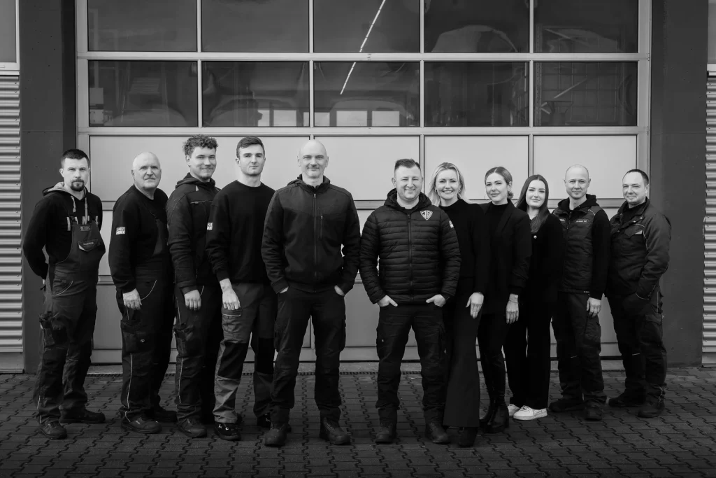 Gruppenfoto des Werkstatt-Teams vor dem Firmengebäude.